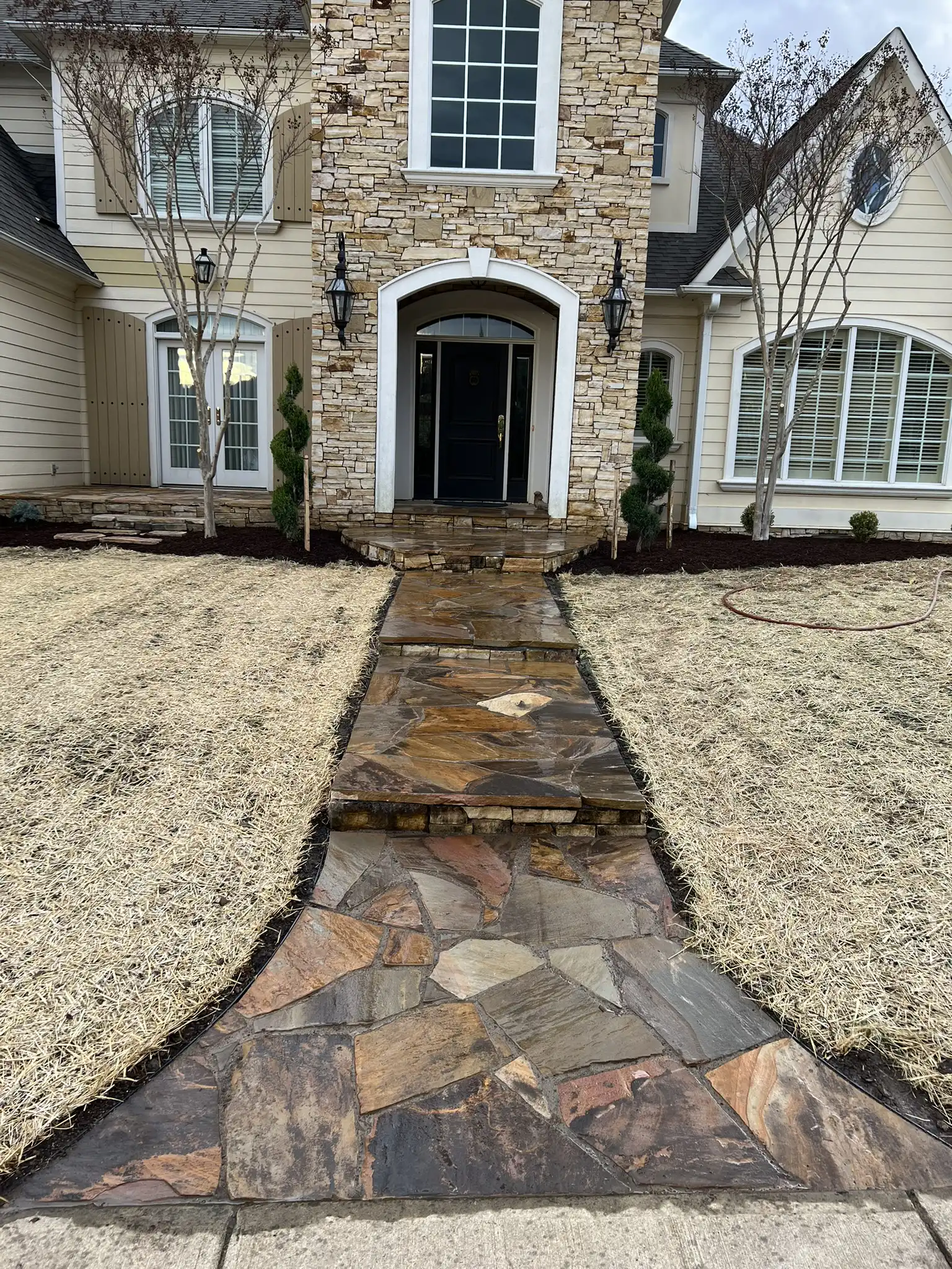 Flagstone walkway through a landscaped yard in Roanoke VA