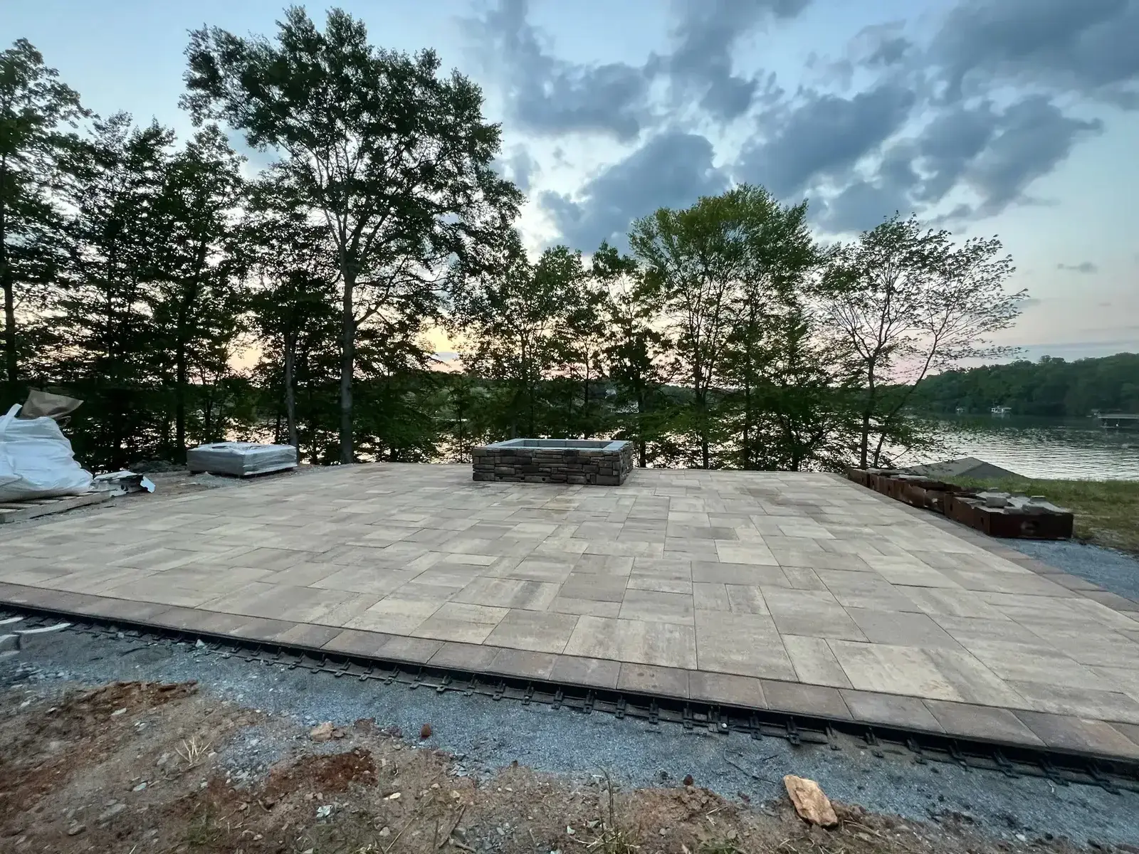 Waterfront YorkTile paver patio with natural stone smokeless fireplace at Smith Mountain Lake — Ridgestone Excavating