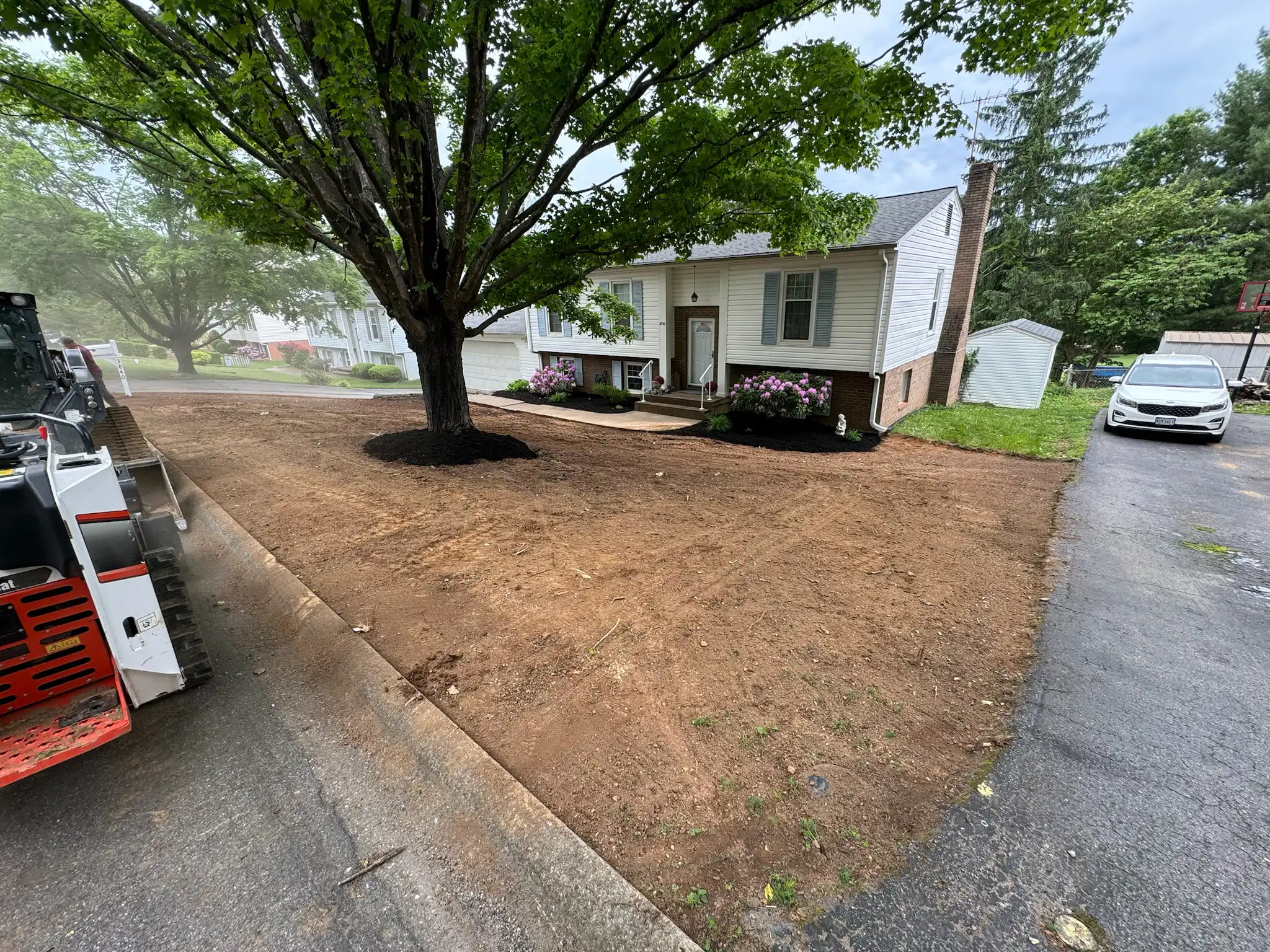 Precision grading project with drainage swale and riprap control